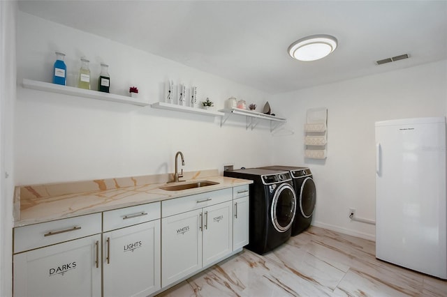 laundry area featuring cabinet space, visible vents, marble finish floor, washing machine and dryer, and a sink