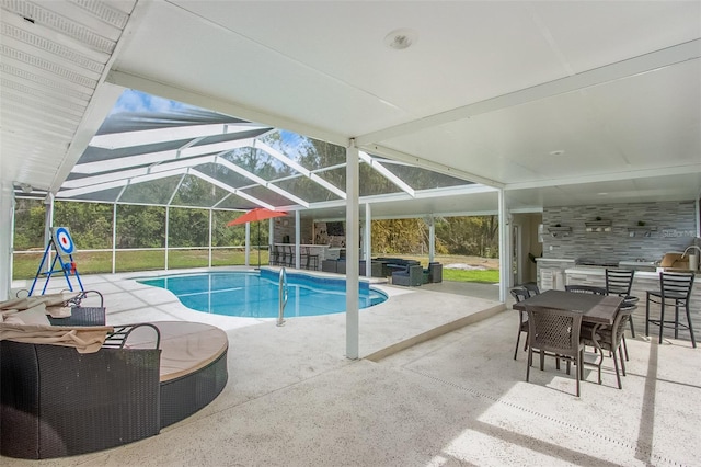 outdoor pool with glass enclosure, outdoor dining area, and a patio area