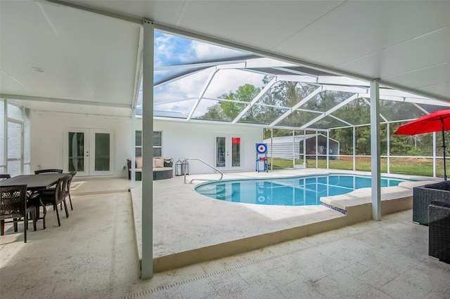 pool featuring french doors, glass enclosure, and a patio