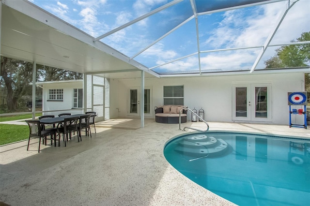 pool with french doors, a patio area, a lanai, and an outdoor hangout area