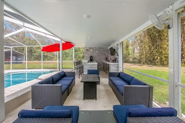 view of patio / terrace with a lanai, outdoor lounge area, and an outdoor pool