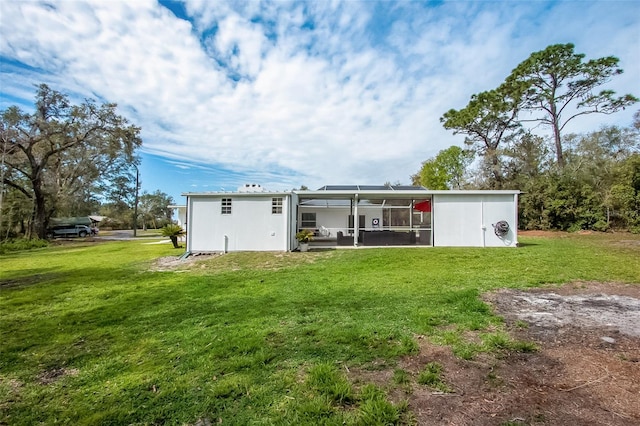 back of property featuring a lawn