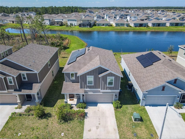 drone / aerial view with a water view and a residential view