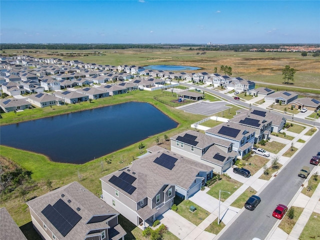 birds eye view of property featuring a water view and a residential view