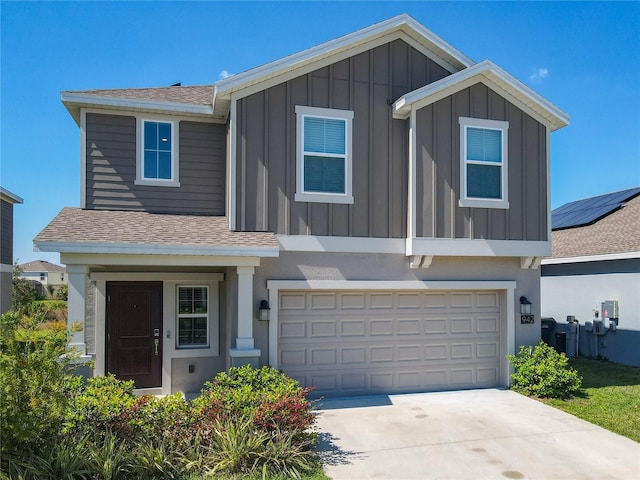 view of front of home featuring board and batten siding, a shingled roof, and an attached garage