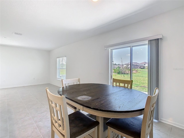 dining area with visible vents, baseboards, and light tile patterned floors