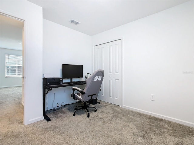 office area featuring baseboards, visible vents, and carpet flooring