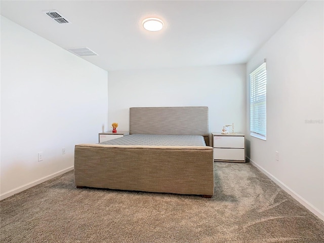 bedroom with baseboards, visible vents, and carpet flooring