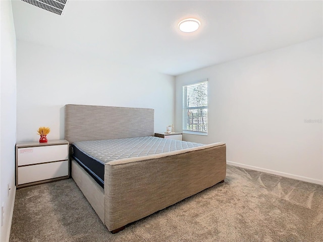 carpeted bedroom with visible vents and baseboards