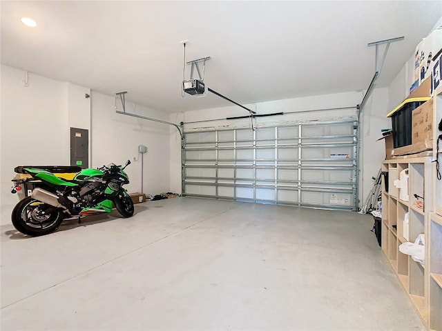 garage with a garage door opener and electric panel