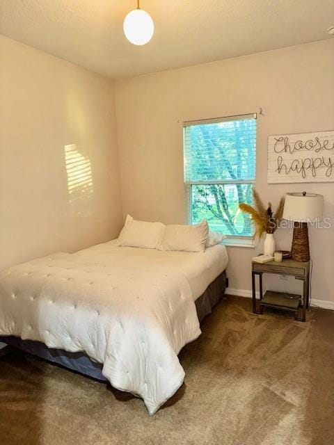 carpeted bedroom with baseboards