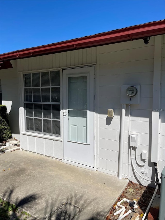 entrance to property featuring concrete block siding