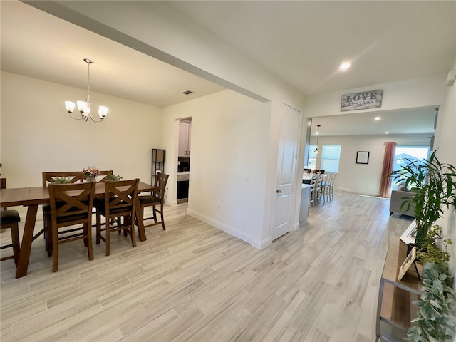 dining area with visible vents, recessed lighting, an inviting chandelier, light wood finished floors, and baseboards