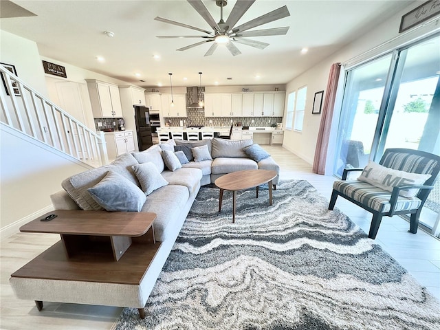 living room with light wood-style flooring, recessed lighting, and baseboards