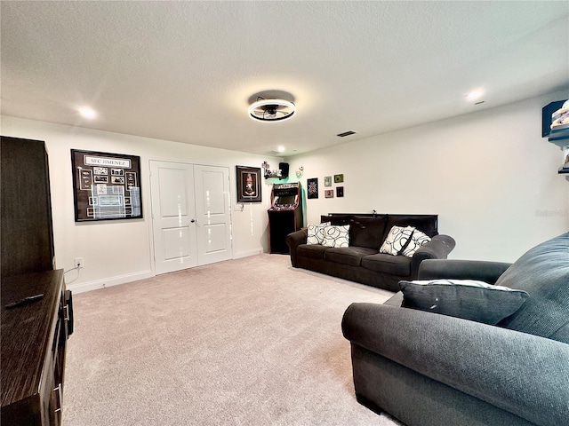 living room featuring visible vents, a textured ceiling, baseboards, and carpet floors