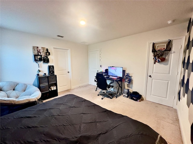 carpeted bedroom with visible vents and baseboards