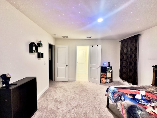 carpeted bedroom featuring baseboards and visible vents