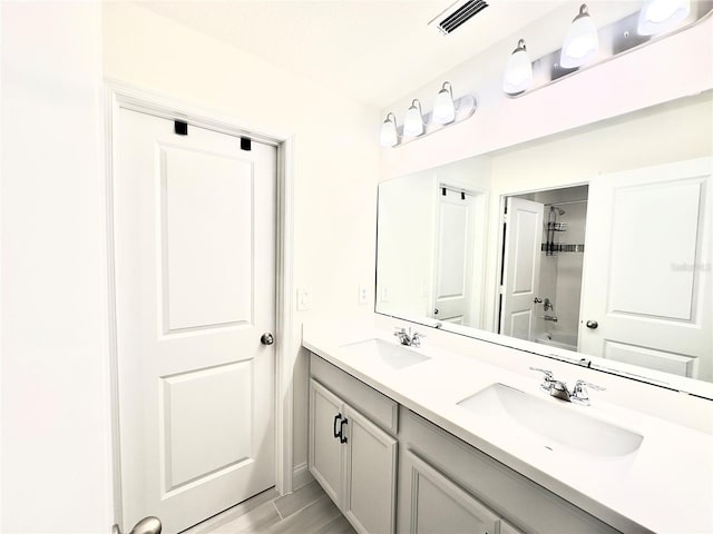 bathroom featuring a sink, visible vents, and double vanity