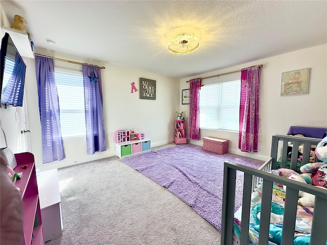 carpeted bedroom with a textured ceiling and baseboards