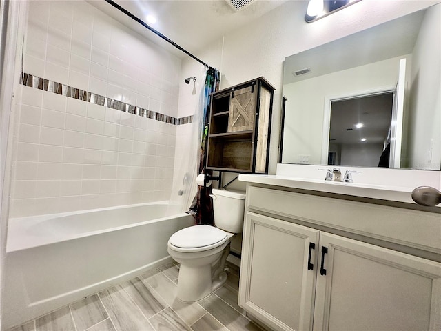 bathroom with vanity, toilet, visible vents, and shower / bath combo with shower curtain