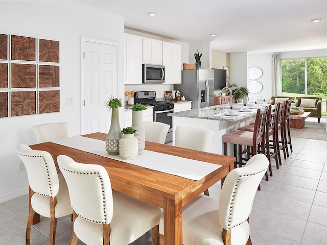 dining room featuring recessed lighting and light tile patterned flooring