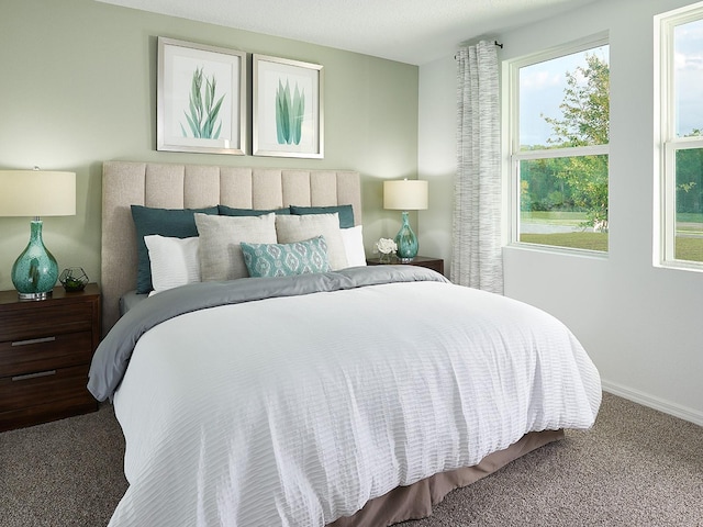 carpeted bedroom featuring baseboards