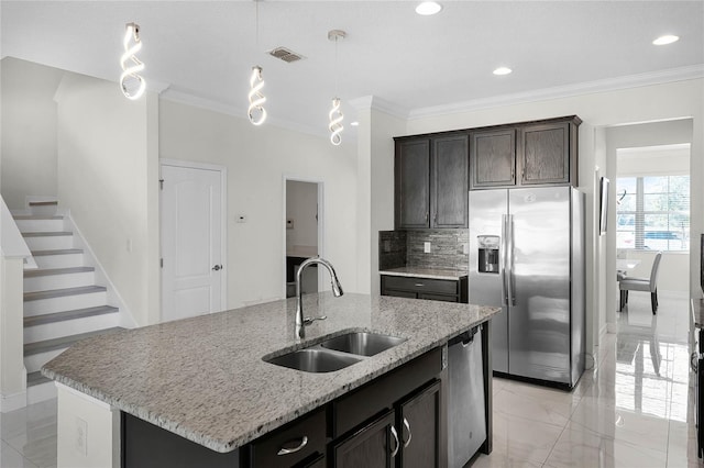 kitchen featuring visible vents, decorative backsplash, stainless steel appliances, crown molding, and a sink