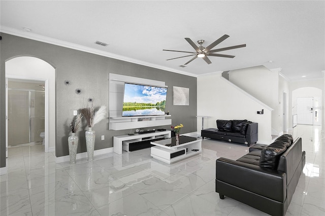 living area featuring arched walkways, visible vents, baseboards, marble finish floor, and ornamental molding