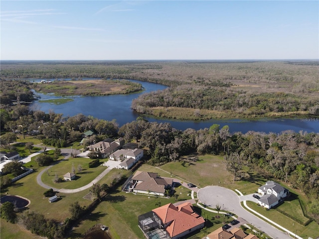 drone / aerial view with a water view and a wooded view