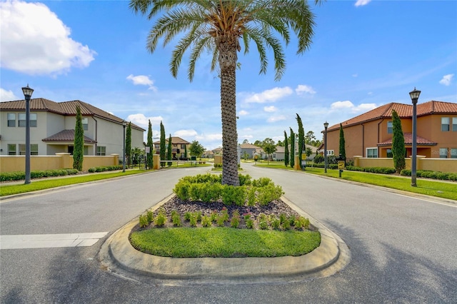 view of street featuring a residential view, curbs, and street lights