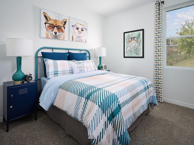 carpeted bedroom featuring baseboards