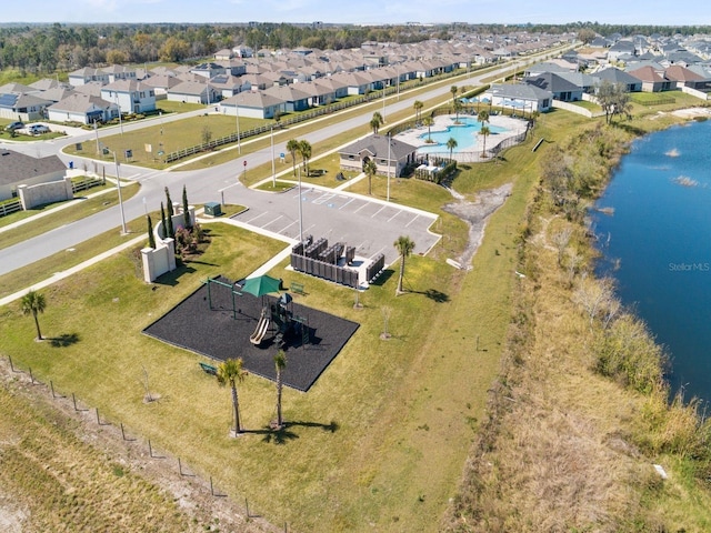 drone / aerial view with a residential view and a water view