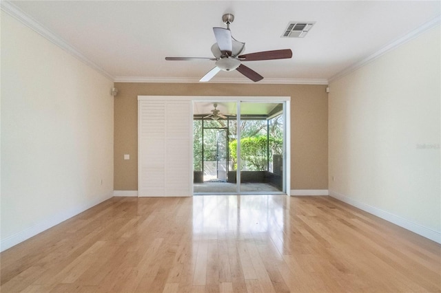 unfurnished room featuring light wood-type flooring, baseboards, visible vents, and ornamental molding