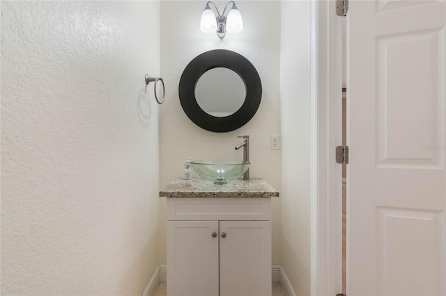 bathroom with vanity and baseboards