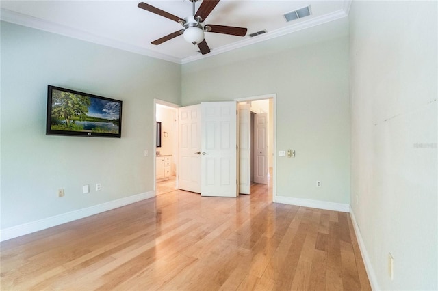 unfurnished bedroom featuring light wood-style floors, visible vents, ornamental molding, and baseboards