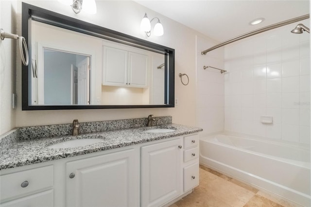 bathroom featuring double vanity, a sink, and shower / tub combination