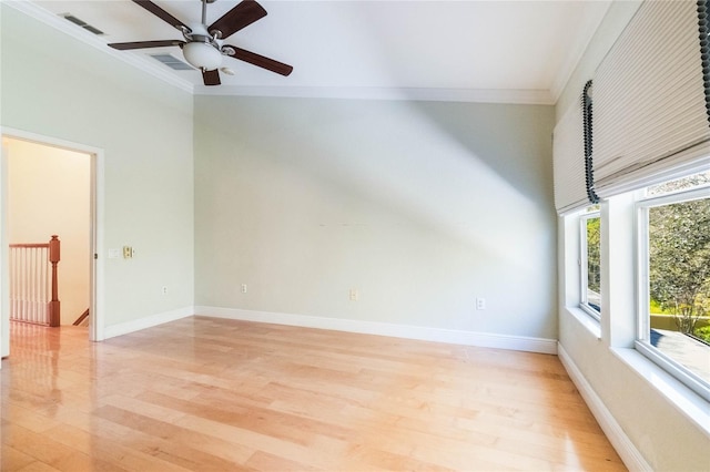 unfurnished room featuring ornamental molding, light wood-type flooring, visible vents, and baseboards