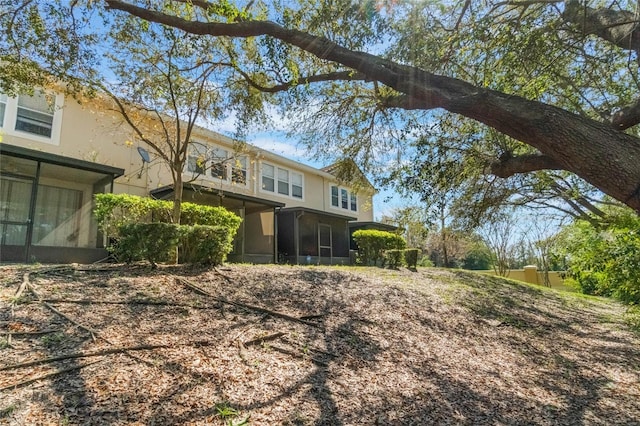 back of property featuring a sunroom