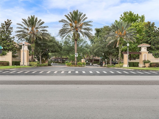 view of road featuring street lights and curbs