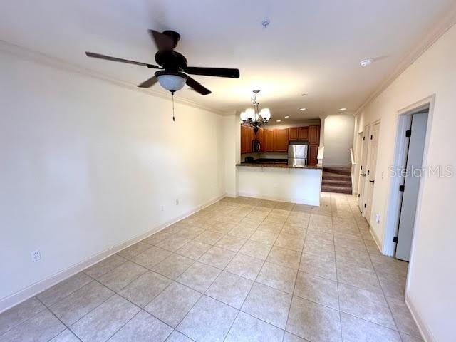 unfurnished living room with light tile patterned flooring, crown molding, and baseboards