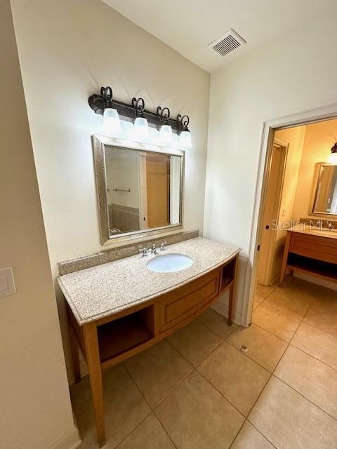 bathroom featuring tile patterned flooring, visible vents, and vanity