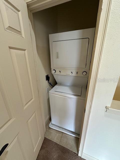 laundry room with laundry area and stacked washer / drying machine