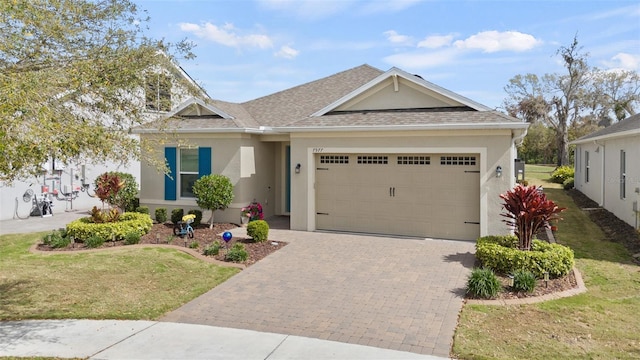 view of front facade featuring decorative driveway, roof with shingles, an attached garage, and stucco siding