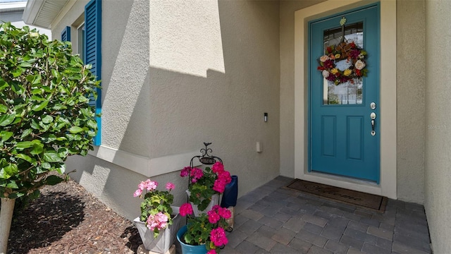 property entrance with stucco siding