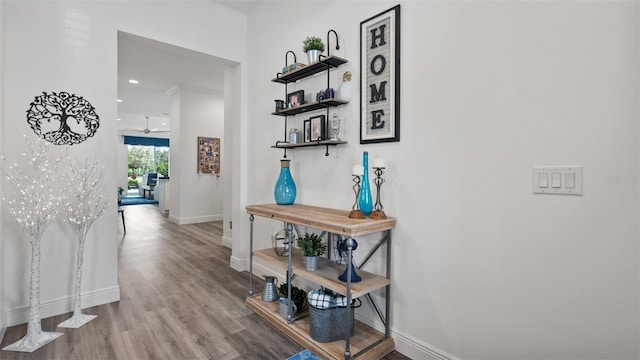 corridor featuring recessed lighting, wood finished floors, and baseboards