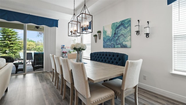 dining area with a chandelier, baseboards, and wood finished floors