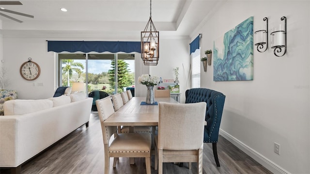 dining room with dark wood-type flooring, recessed lighting, a notable chandelier, and baseboards