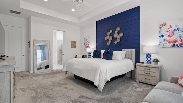 carpeted bedroom featuring ceiling fan, visible vents, a raised ceiling, and recessed lighting