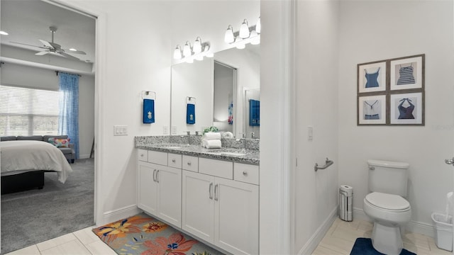 ensuite bathroom featuring double vanity, toilet, ceiling fan, ensuite bathroom, and a sink