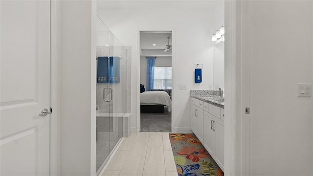 ensuite bathroom featuring a shower stall, a ceiling fan, connected bathroom, and vanity